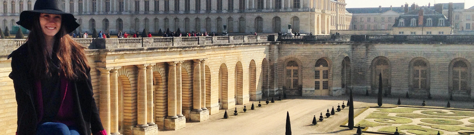 Student in the foreground with the palace of Versailles (Paris, France) in the background